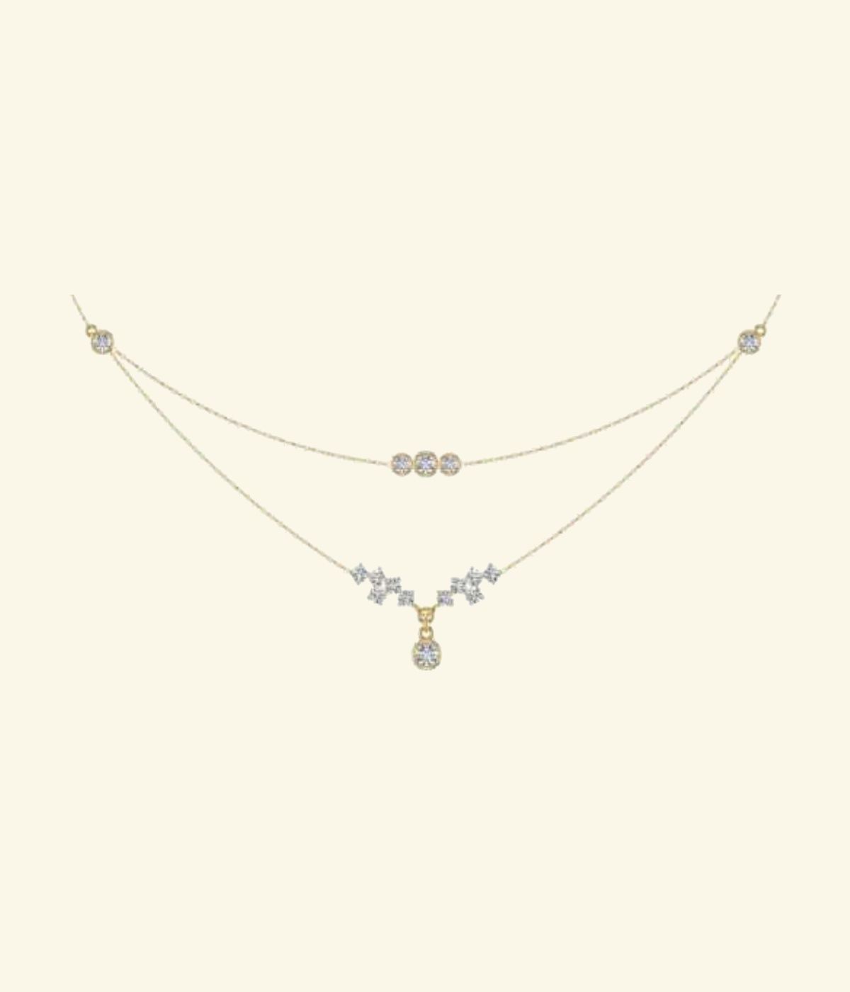 Layered double-chain necklace with central diamond cluster and pendant drop