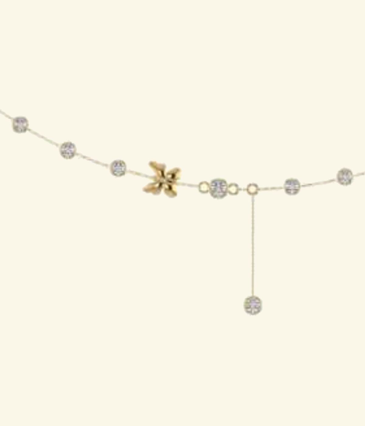 Fine chain necklace with pavé starburst charm and scattered diamond accent drops