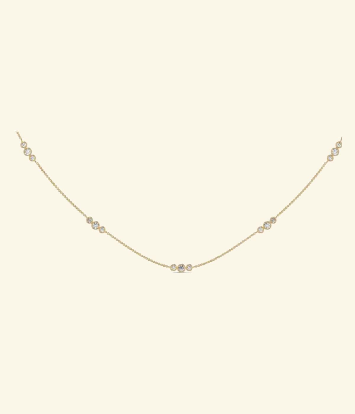 Minimal asymmetric V-neck station necklace with small scattered diamonds on fine chain